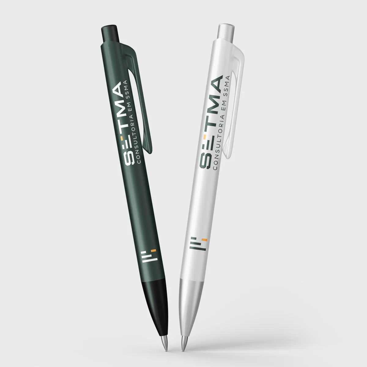 Duas canetas, uma verde e uma branca, com a marca SETMA impressa no corpo